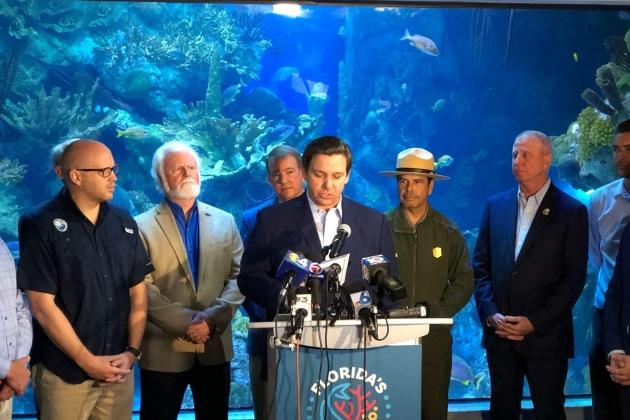 Gov. DeSantis speaks about corals, with Mote President & CEO Dr. Michael P. Crosby (second from left) and state leaders.