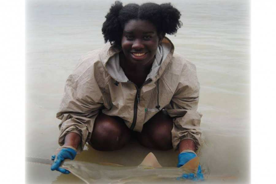 Photo: Jasmin Graham with a sawfish. Credit Jasmin Graham/Minorities in Shark Science