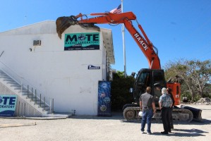 A large front excavator is readied for action during a demolition kickoff ceremony at Mote Marine Laboratory’s facilities on Summerland Key, Fla., where old buildings are being removed so the Lab’s new research and education facility can be built.