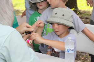Cooper Nickelson at the Fly Tying station at Mote Marine Laboratory’s Snook Shindig Teach-A-Kid Fishing Clinic. 