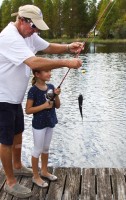 Capt. Scotty Moore and Anabel Procel-Cacka and her fish at the Dock Fishing station at Mote Marine Laboratory’s Snook Shindig Teach-A-Kid Fishing Clinic.