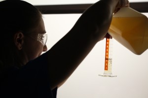 Under reduced lighting, Mote Chemist Susan Launay measures a sample for chlorophyll filtration & analysis.