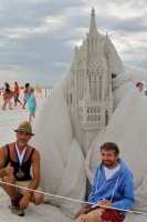 Master sand sculptors Leonardo Ugolini (left) from Forli, Italy, and Enguerrand David from Brussels, Belgium, pose with their first prize winning sculpture, 