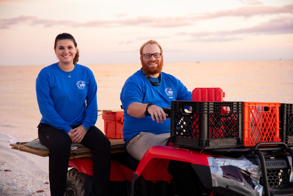Mote scientists ride an ATV on the beach as they search for nesting sea turtles