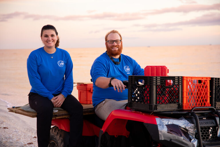 Mote scientists ride an ATV on the beach as they search for nesting sea turtles