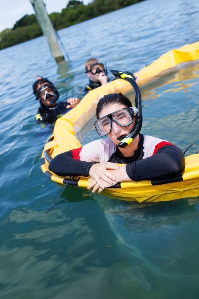 Jess Frankle snorkels in a limnocorral, a piece of equipment to section off water for a red tide mitigation research project.
