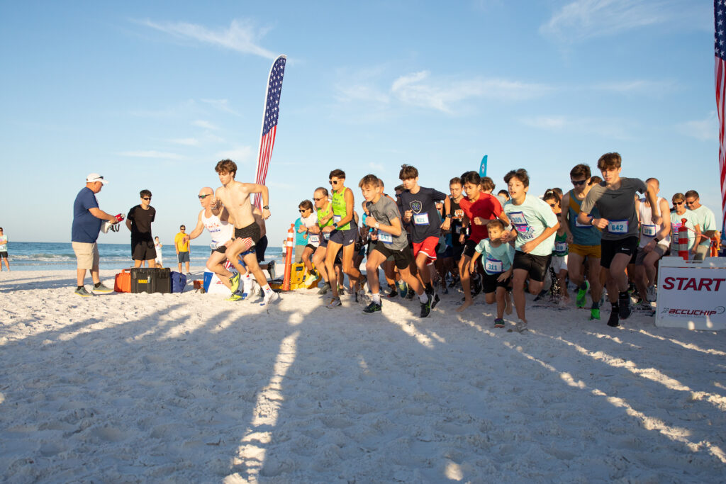 Runners start the 5K race during Mote's Run for the Turtles on Siesta Beach, Florida.