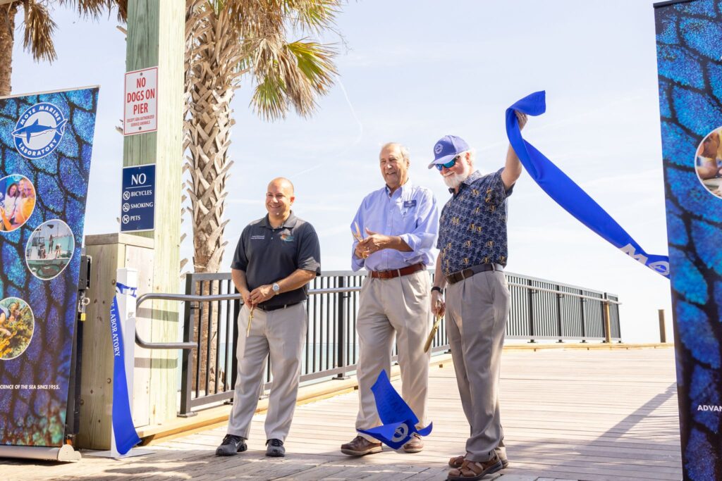 Mote President & CEO Dr. Michael P. Crosby joins Dan Murphy, Mayor of the City of Anna Maria, and Kevin Van Ostenbridge, Chairman of the Manatee County Board of County Commissioners, at the ribbon-cutting event for Mote's new Mote's Marine Science Education & Outreach Center at Anna Maria City Pier.