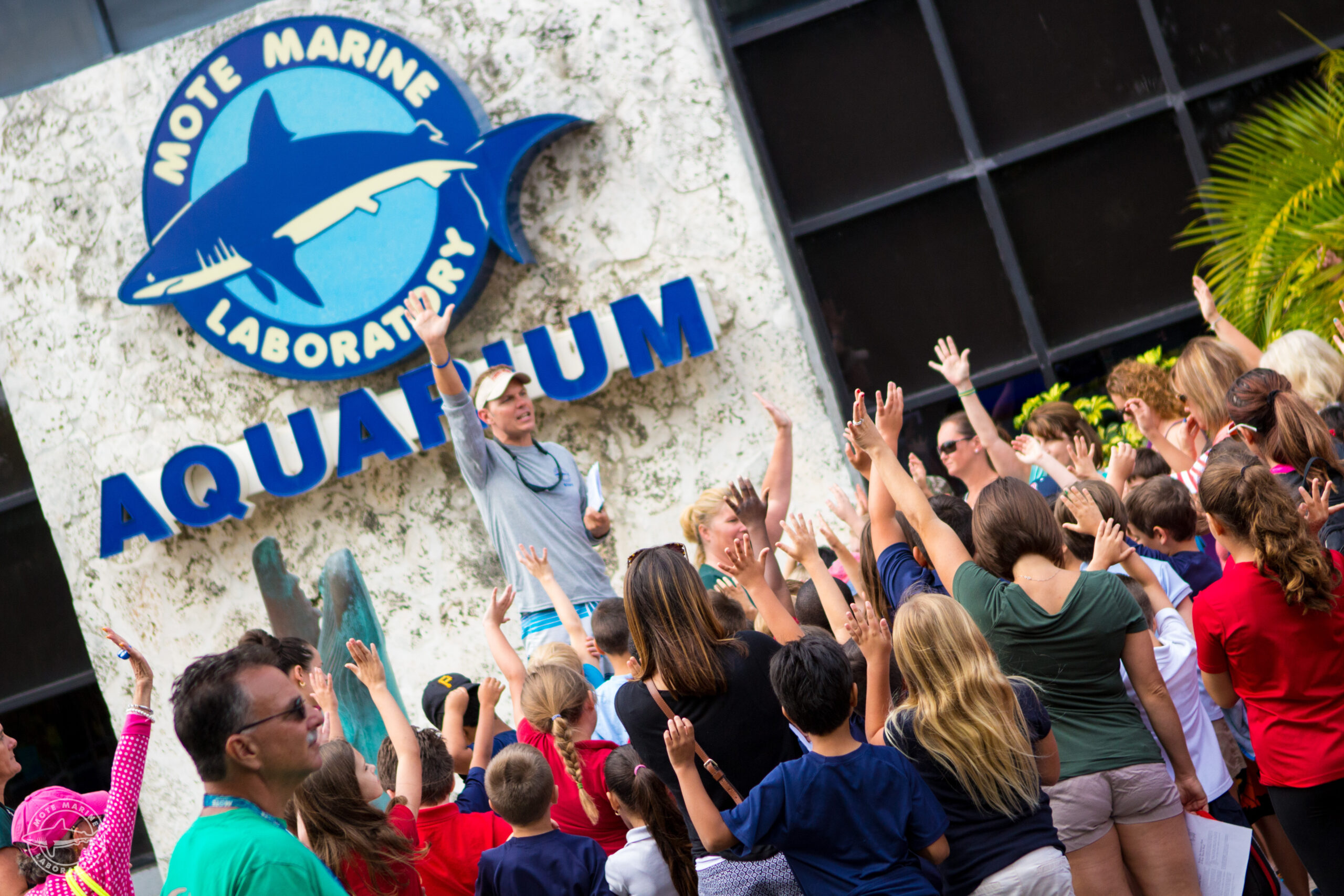 A school group gathers outside Mote Aquarium for a field trip.