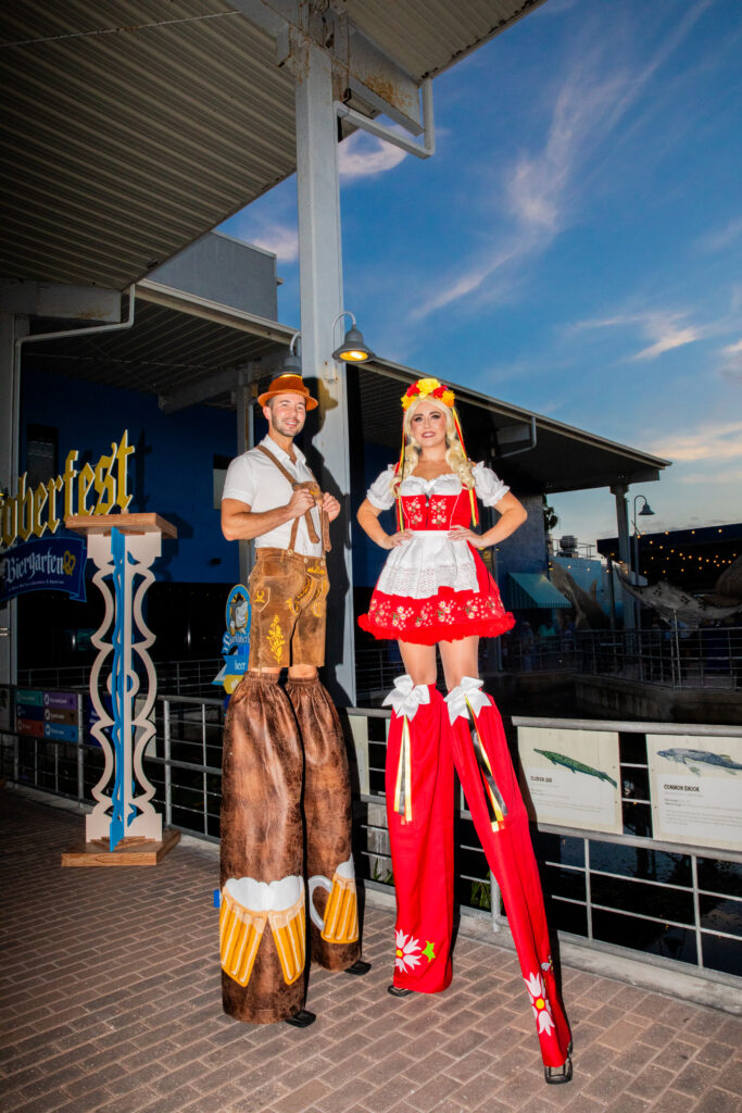 Performers on stilts at Sharktoberfest 2023 at Mote