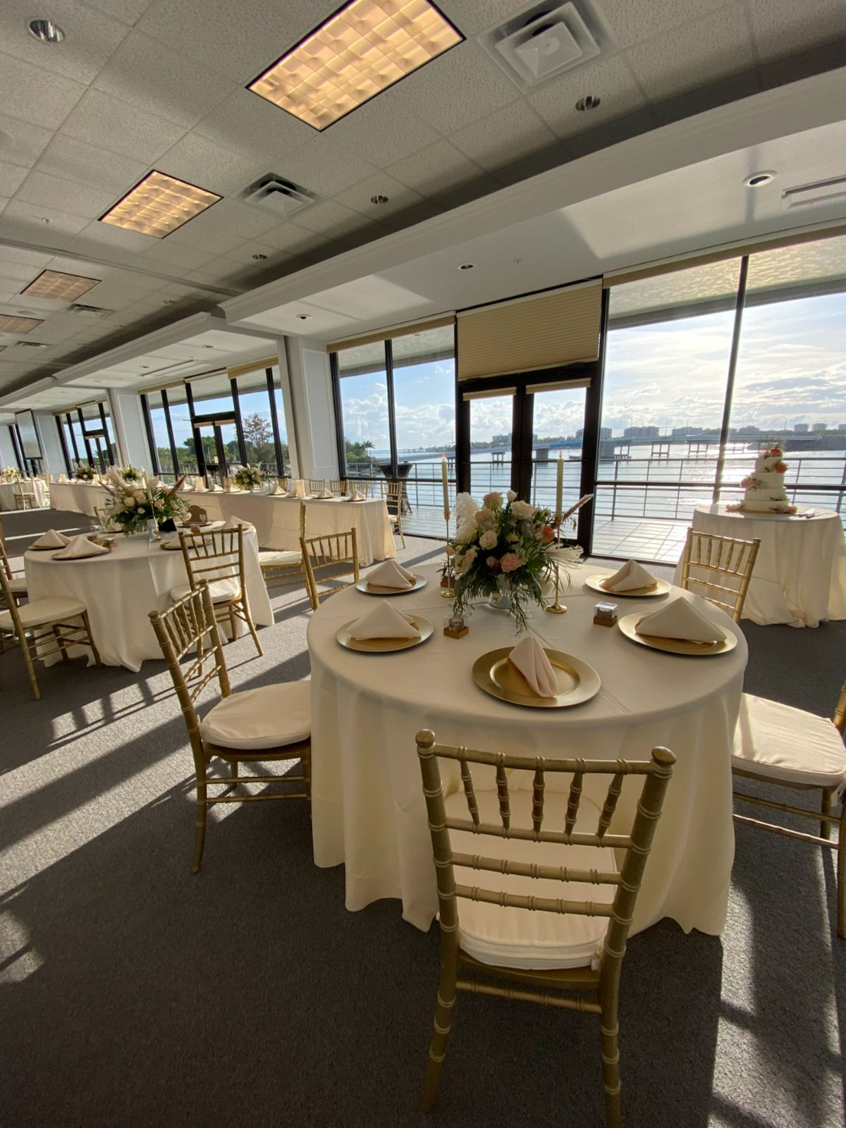 Banquet Table set up in a room with a wall of windows overlooking the Sarasota gulf