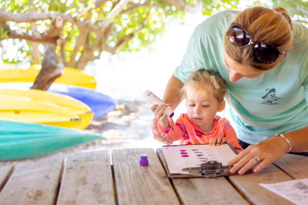 Parent and child work on activity at Shark Pups